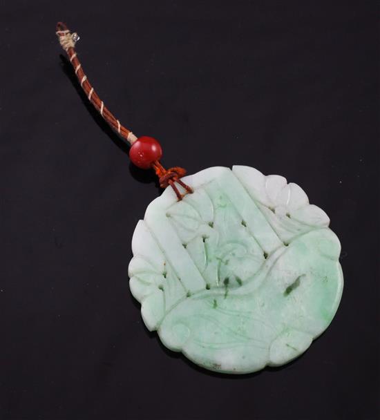 A carved jadeite circular disc pendant, 2in.